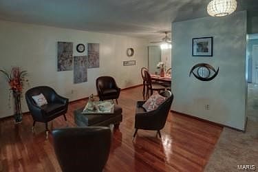 Look at these floors glow.  They have been refinished throughout the home. Here the welcoming living room and separate dining ro