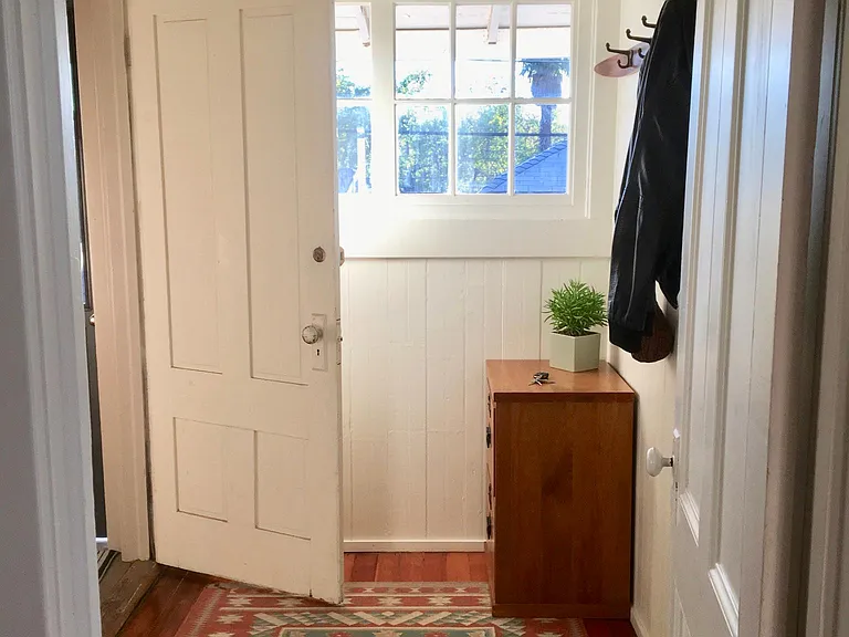Backdoor to deck, back garden, and laundry room.
