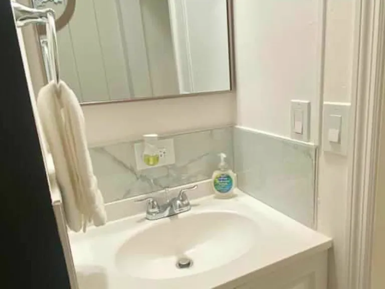 Bathroom with fresh towels, towel racks, and essential amenities.