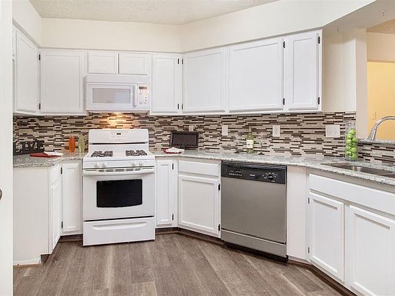 Recent Granite Counter Tops, Tile Backsplash with Glass Look Inserts, Stainless Sink with Updated Faucet, and New Built-In Microwave