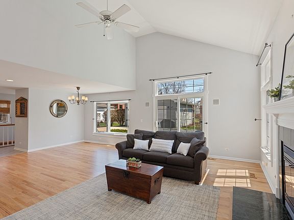 Family Room with vaulted ceilings and fireplace with open floorplan.
