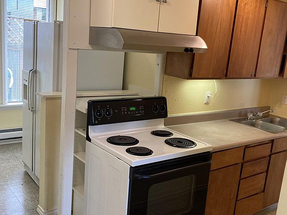 Kitchen with range hood, self-cleaning range, extra-large refrigerator.