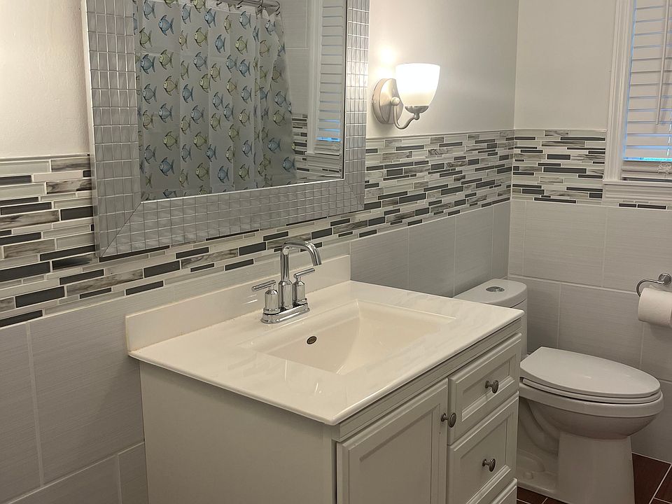 Remodeled bathroom, tile up wall for easy cleaning, tile flooring.
