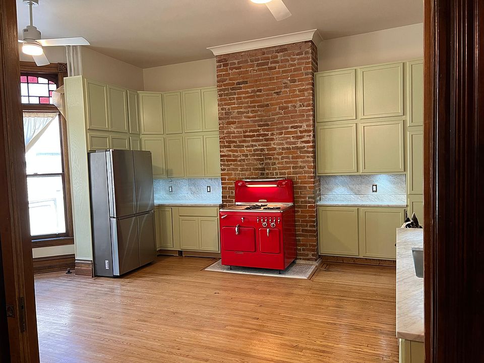 Looking into kitchen from DR. Renovated kitchen with ss refrigerator and dishwasher, beautiful Chamberlin stove, marble countertops and backsplash. Kitchen island to be island.