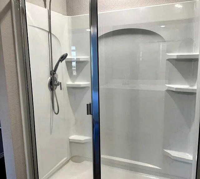 Clean and modern primary bathroom with ample space and storage.