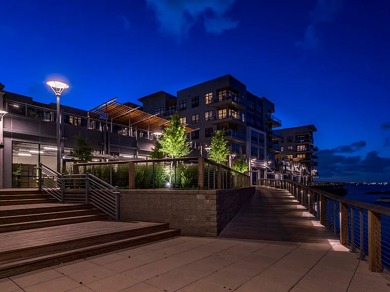 Stroll along the water at night and enjoy serene, sparkling views