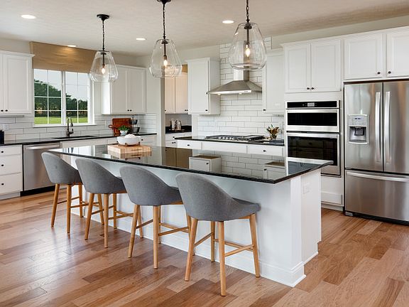 Gourmet Kitchen with White Cabinets and Pendant Lighting