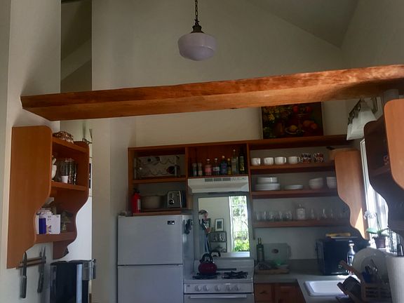 High ceilings, open gallery kitchen, ideal for cooking and entertaining. custom open shelves, & 
 lighting.