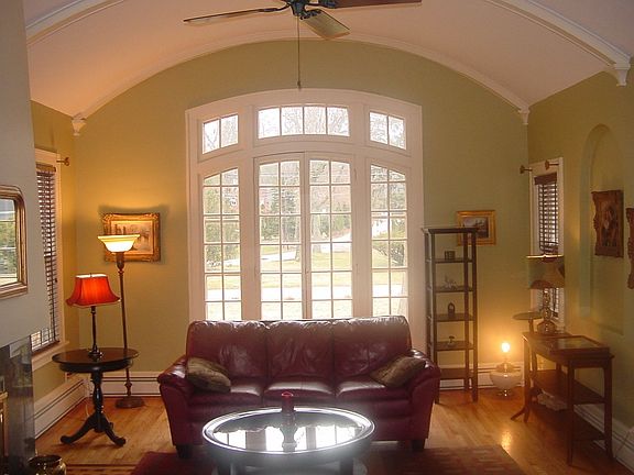 Unique barrell ceiling & marble fireplace highlite the living room.