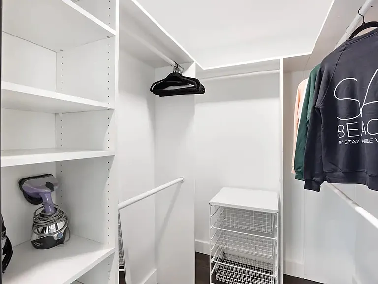 Discover convenience and elegance in our spacious walk-in closet, perfect for organizing your wardrobe and personal items.