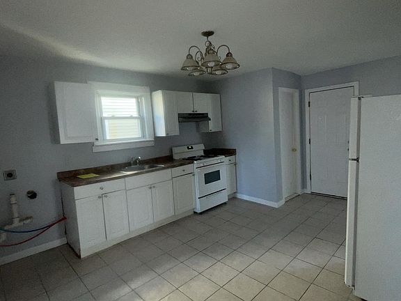 Spacious full kitchen equipped with washer and dryer hookups.