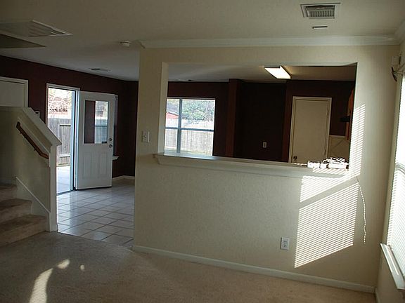 View of Kitchen, breakfast area and stairs to upper level. Breakfast bar serves as pass-thru to kitchen.