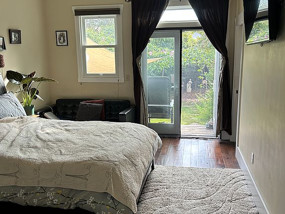 Master bedroom with doors to large garden