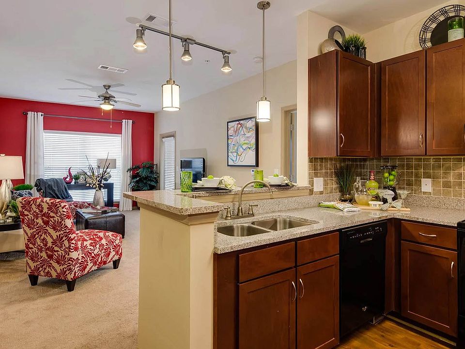Open Kitchen with deep sink and bar for dining overlooking, spacious carpeted living room