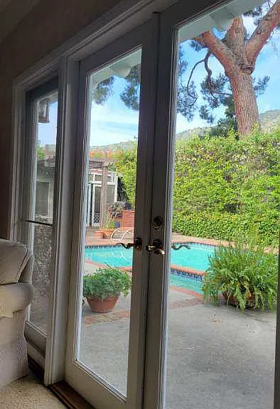 View to the deck and a shared pool.