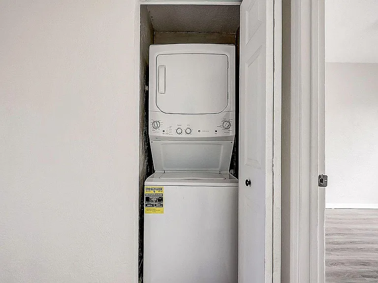 Compact and efficient in-unit laundry with stacked washer and dryer, enhancing convenience and modern living.