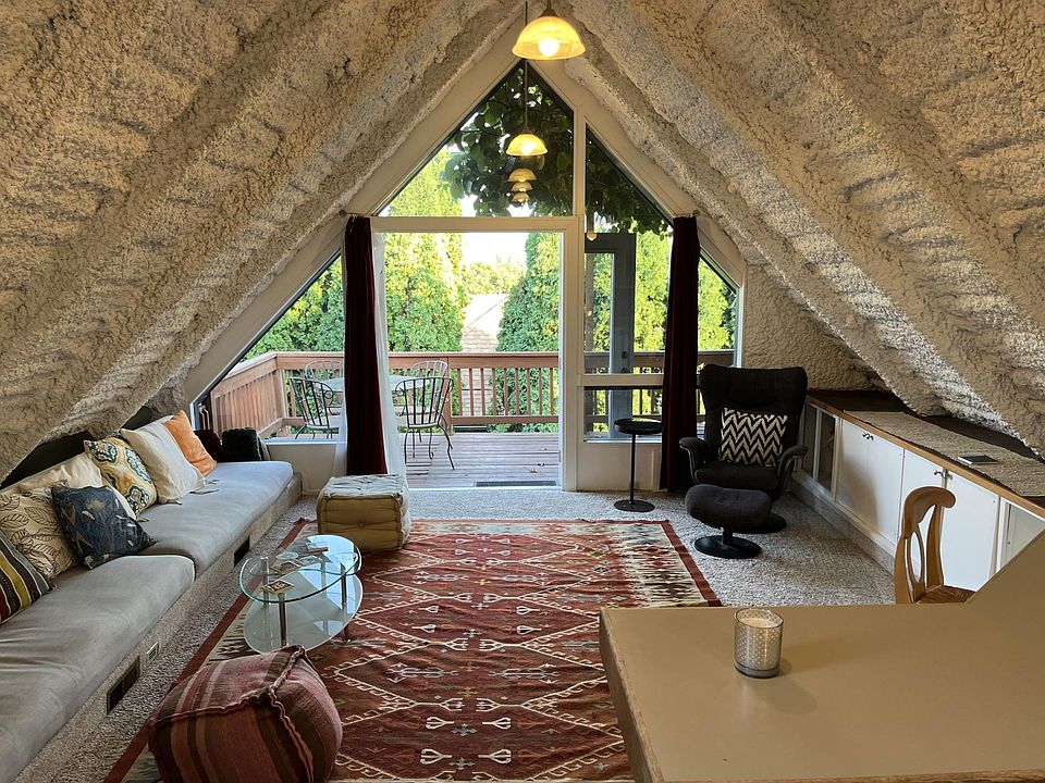Converted attic turned into unique living room with built-in sofa. Opens onto large deck facing the Cascades