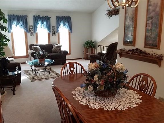 A view of the formal dining room into the living room showing off the large Anderson windows with warranty.