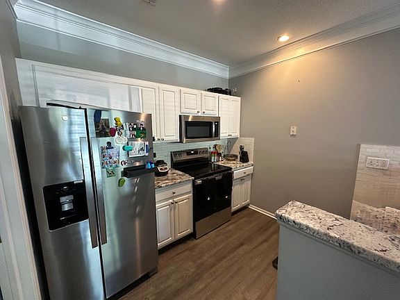 Kitchen with newer SS appliances and granite counter tops.