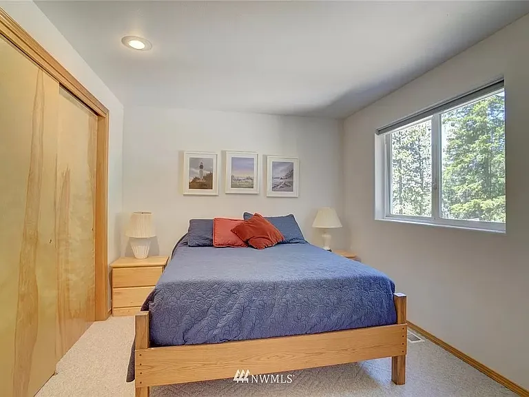 Bedroom 1 on main floor with queen bed and spacious slide in closets