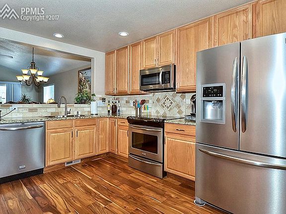Kitchen Featuring Granite Counters with Custom Travertine Tile Back-splash, Hand