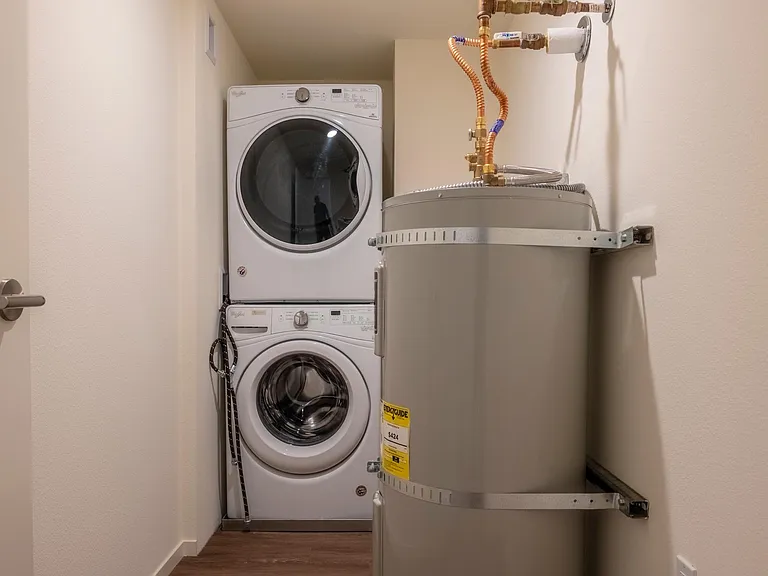 In unit washer/dryer with room for storage.