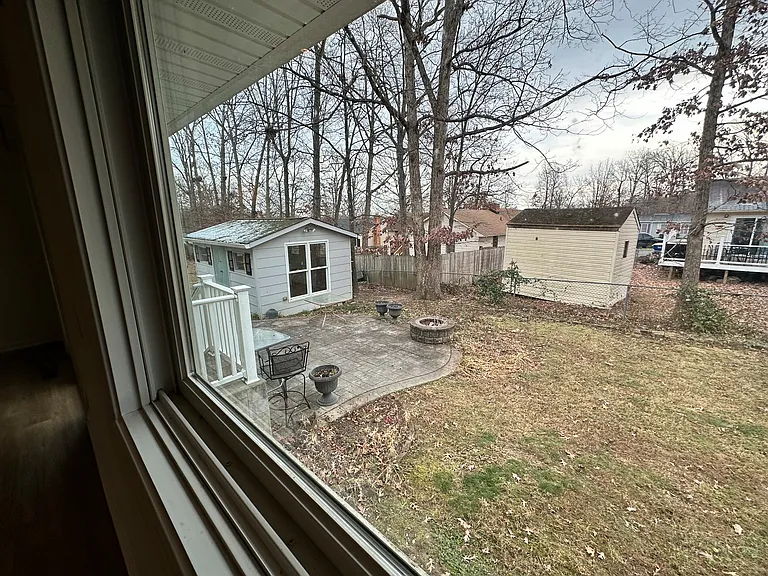 Another backyard view from the large window in kitchen. Large shed with electricity - perfect to use as a hobby space, features a huge window. Also a stamped patio, accessible from steps leading off the dining room and the primary suite.