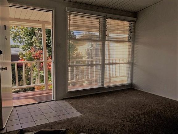 Living room entry looking from upstairs out to the many trees