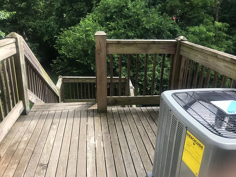 Back deck with staircase leading down to back yard