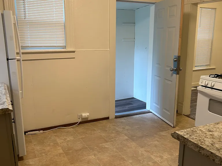 Kitchen from hallway by bathroom and laundry room