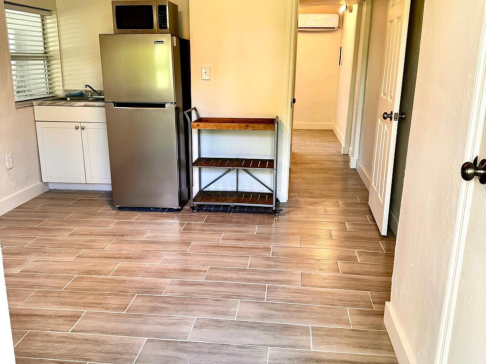 Living room with kitchen / front door entrance