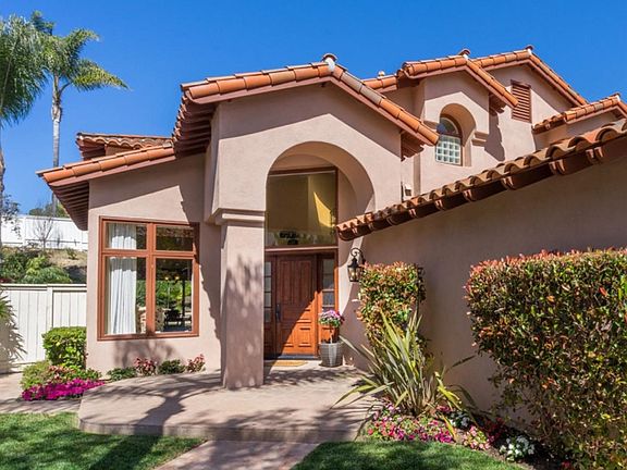 Rich new entry doors with Baldwin hardware and an elegant transom window bath the entry with light.