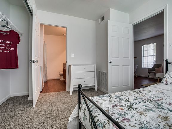 Carpeted master bedroom with closet
