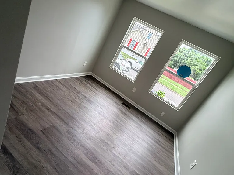 Spacious bedroom featuring a closet and bright windows that provide plenty of natural light.