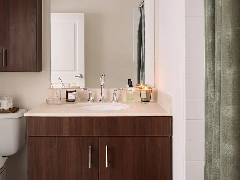 Bathroom vanities with under-cabinet storage and large mirror.
