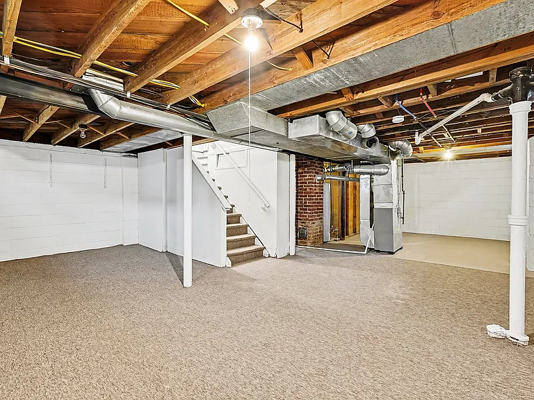 Clean, carpeted basement for additional living space.