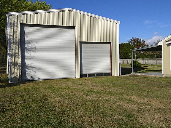 Includes a 34x42 storage bldg/workshop with 30 amp elec service! Built in 2009; Windstorm Certified!