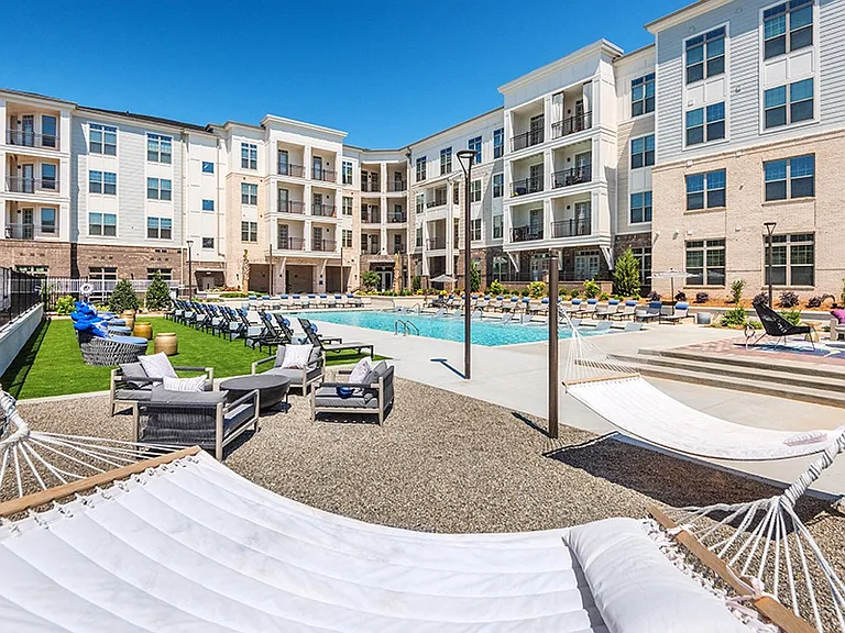 The outdoor lounge features hammocks, TV and fireplace