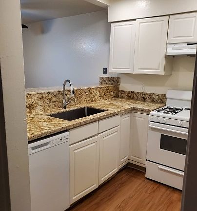 Remodeled kitchen with new granite and newly painted cabinets.