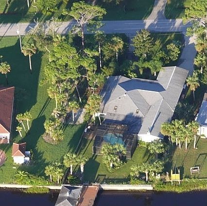 From river over boathouse + pool
