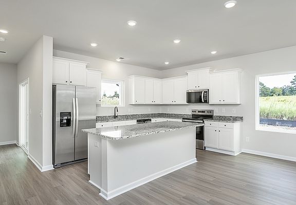The kitchen has designer wood cabinetry