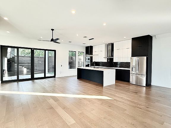 Kitchen, living, dining, gated backyard with covered entertainment patio