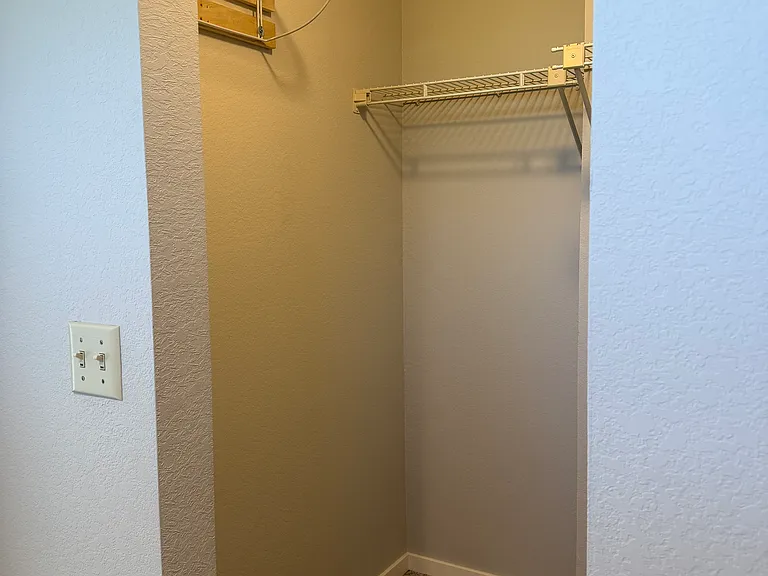 left side of primary walk in closet
