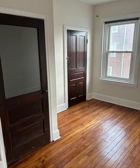 Front bedroom with original two-suit closet and additional closet.