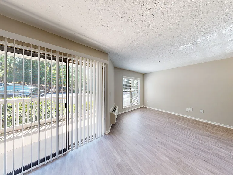 Bright and airy living space with private patio or balcony Bright and airy living space with private patio or balcony