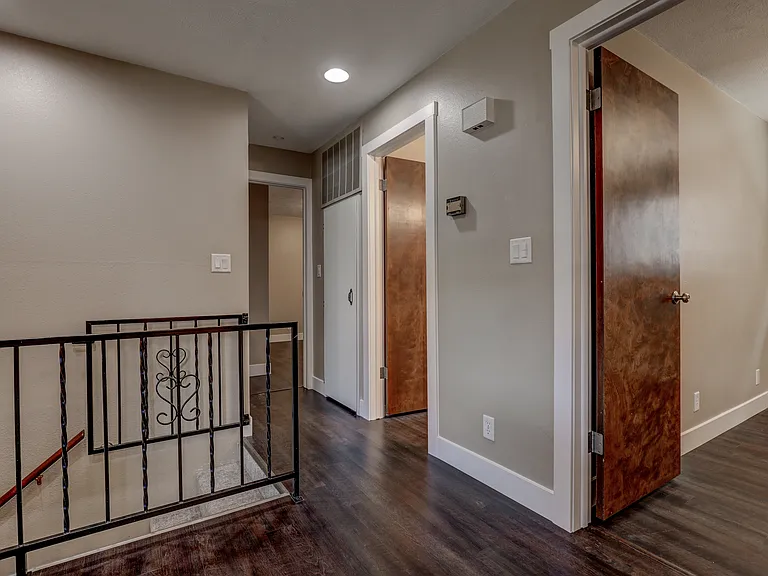 Hallway to living area, bedrooms, bathrooms, and basement