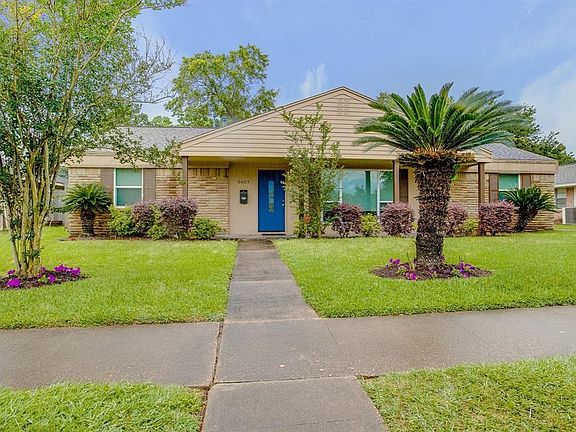 Beautiful home with covered slate front porch and lovely trees!