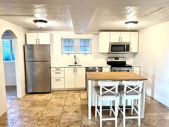 Kitchen with new quartz countertops, and kitchen island with seating and storage.