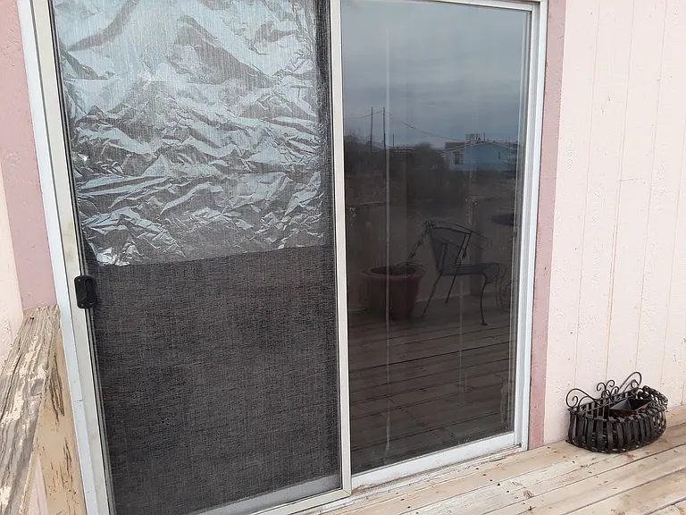 Sliding Glass Door with black-out curtains back of Dining Room.