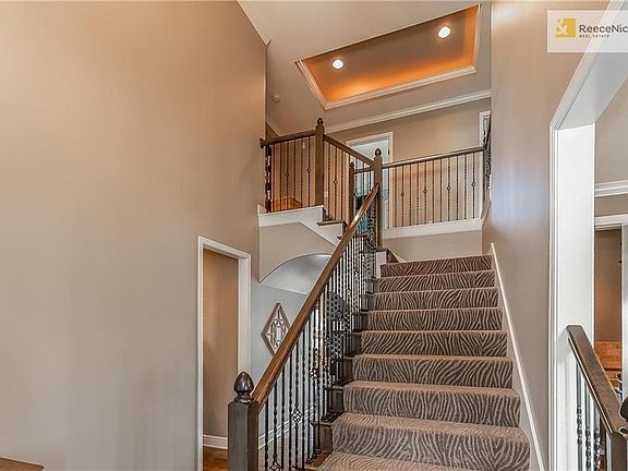 Grand Staircase with Lighted Tray Ceiling, Designer Carpet